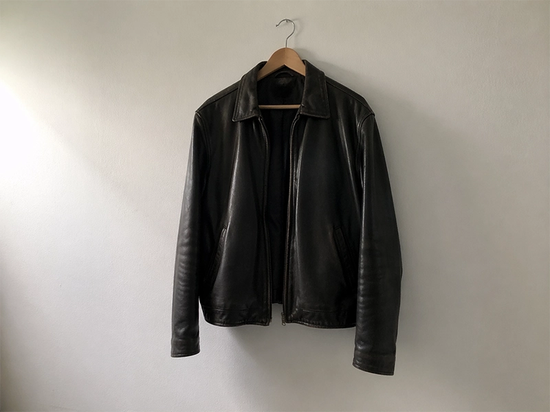 Black leather jacket hanging on a wall