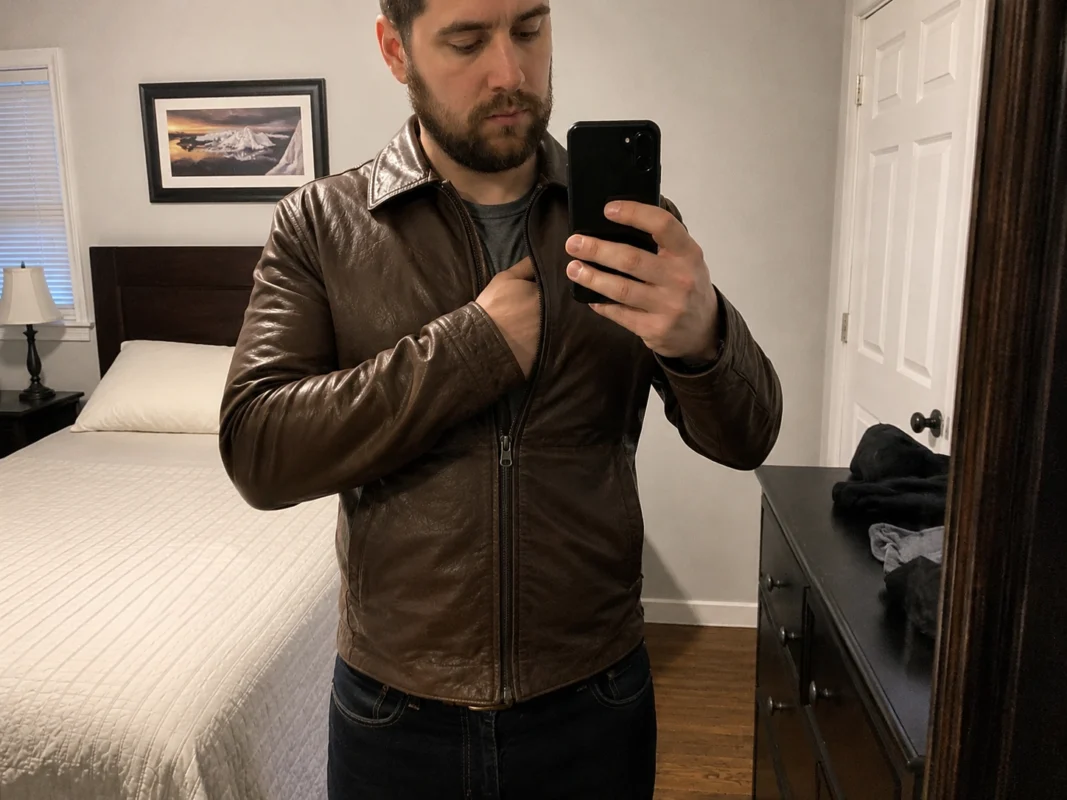 man checking the chest of a brown leather jacket