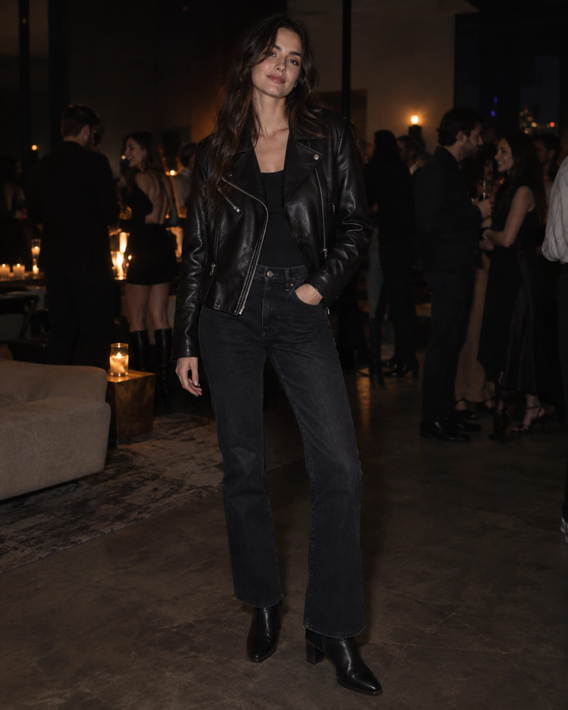 woman in black leather biker jacket over dark denim and boots